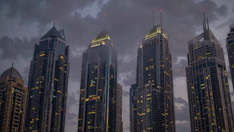 illuminated skyscrapers rising majestically from low hanging clouds at dusk, creating a captivating and futuristic urban landscape in dubai, where modern architecture meets atmospheric beauty