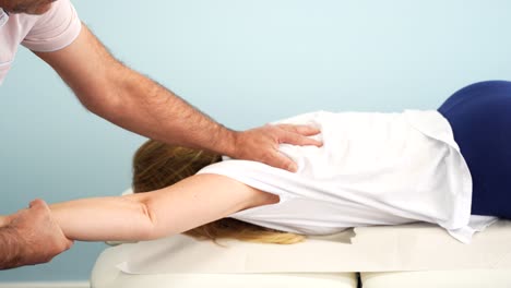 blonde woman in a physiotherapy session to help relieve arm pain