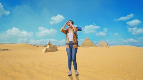 full body of asian female hiker with mountaineering backpack smiling and making binoculars gesture then looking around while traveling in pyramid of giza