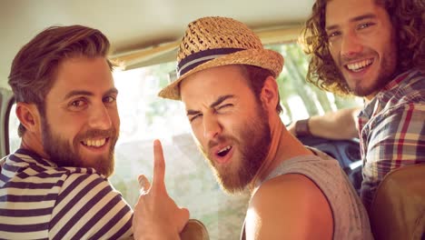 Portrait-of-diverse-group-of-friends-sitting-in-car-looking-at-camera-and-smiling