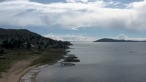 Beautiful-aerial-drone-shot-of-calm-water-beach-at-the-Titicaca-lake-located-in-Peru