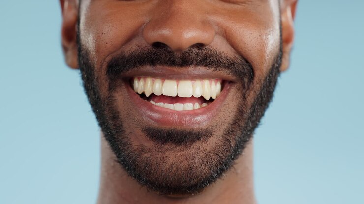 Smile, closeup and black man with teeth in studio