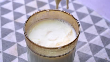 milk and yogurt in glass with spoon