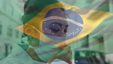 animation of flag of brazil waving over woman in face masks