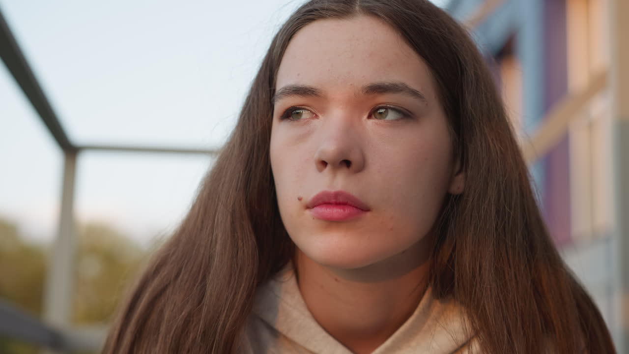 Woman with frustrated look closeup. Depressed woman barely holds back tears reflecting on loss. Young woman wrestles with feelings of depression