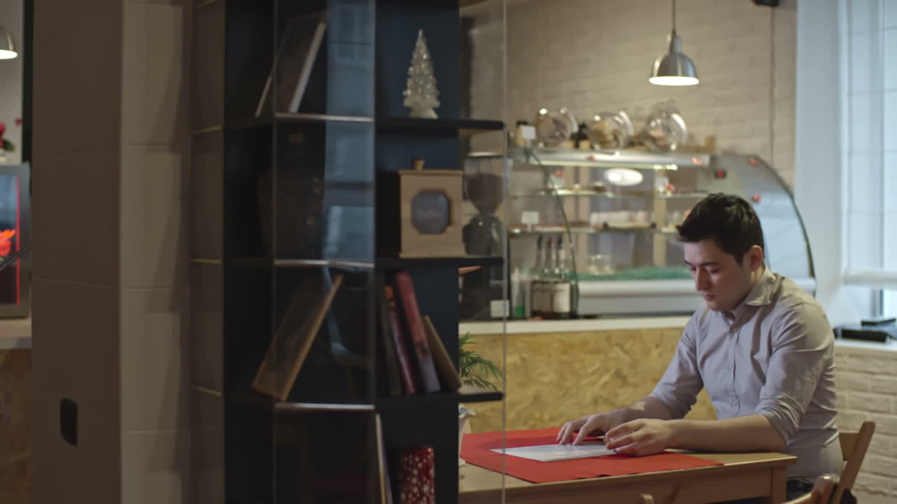 커피숍 주인과 매니저가 소규모 비즈니스인 커피숍의 계정에 대해 논의하고 있습니다.