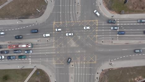 aerial: cars driving on a street on a rush hour and pedestrians walking on zebras