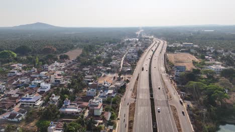 aerial view of rural karnataka. features farmlands, roadside facilities, and extensive coconut trees. perfect for showcasing infrastructure and regional development
