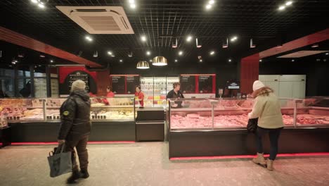 a meat shop specializing in fresh products. the scene shows neatly arranged meat on display counters, showcasing high-quality cuts in a clean and professional retail environment