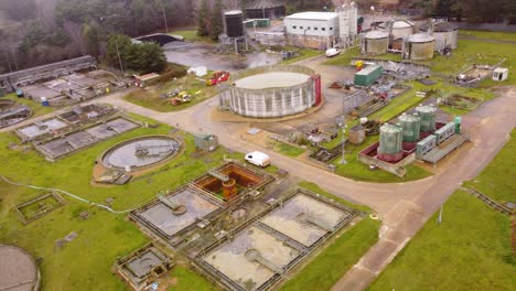 industrial wastewater treatment plant factory in thetford, norfolk - aerial drone shot : forest destruction concept