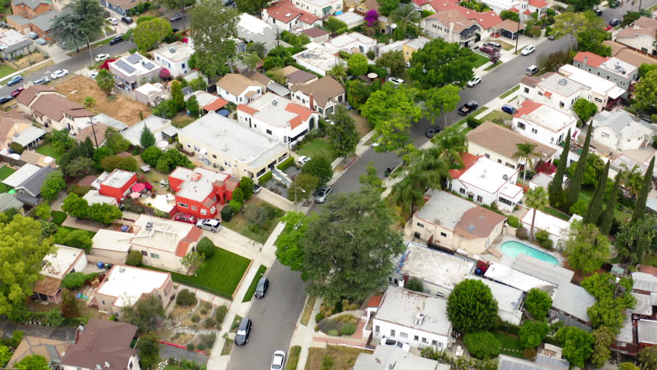 Aerial view of a residential suburban neighborhood with houses and green trees
