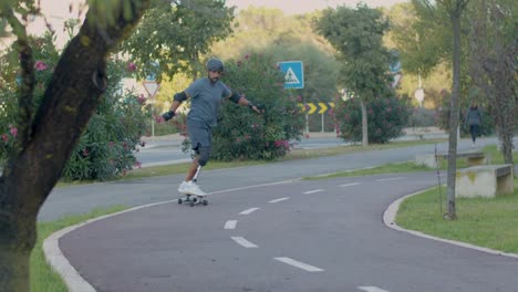 mid adult man with prosthetic leg skating on board in park