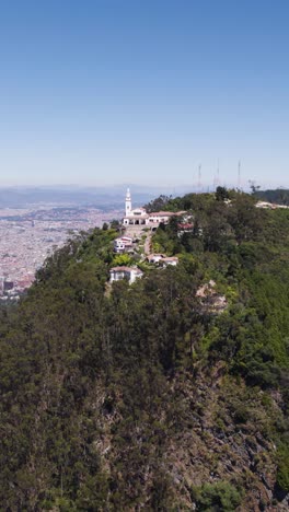 aerial view of the monserrate church and bogota cityscape in colombia. vertical video