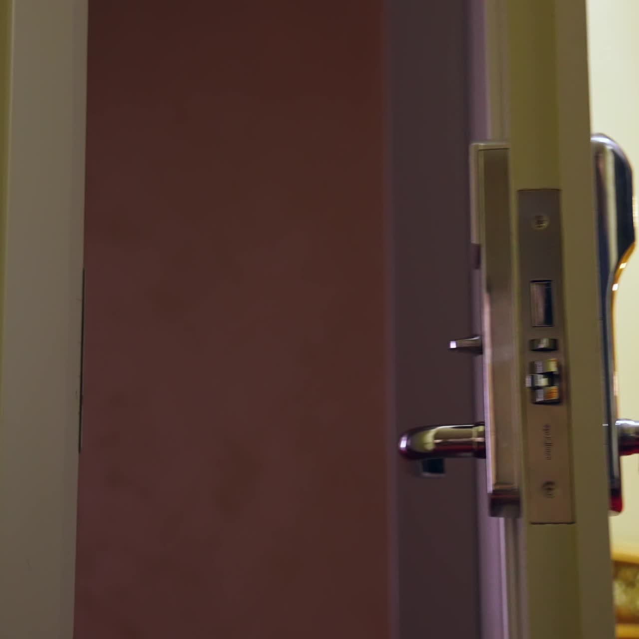 Unrecognizible man arrived to hotel and opens the room with electronic key. Selective focus on a door handle