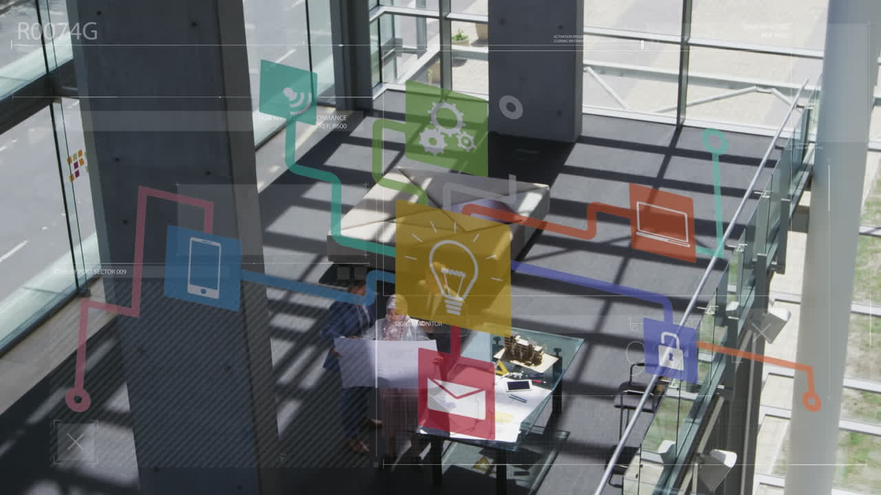 animación de una red de iconos digitales contra una vista aérea de personas que trabajan en la oficina.