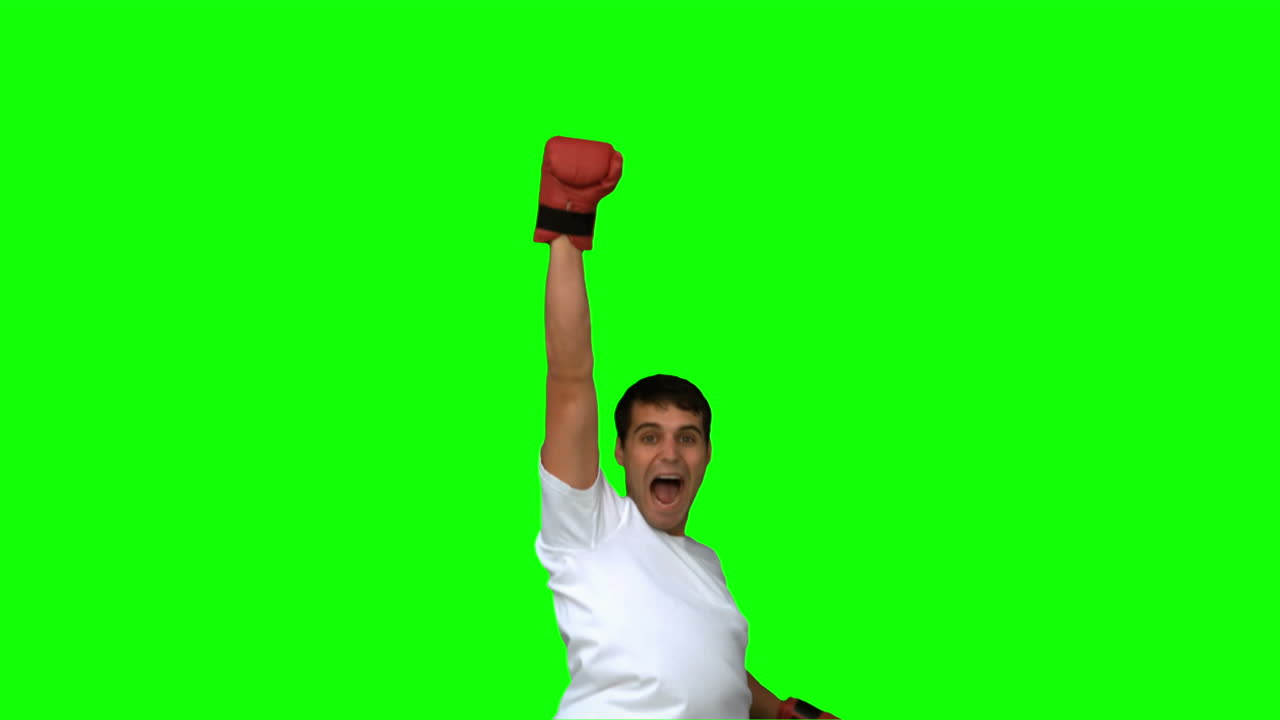 Man wearing boxing gloves on green screen