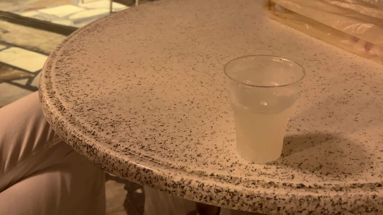 Two drinks resting on a stone table at night in Crete