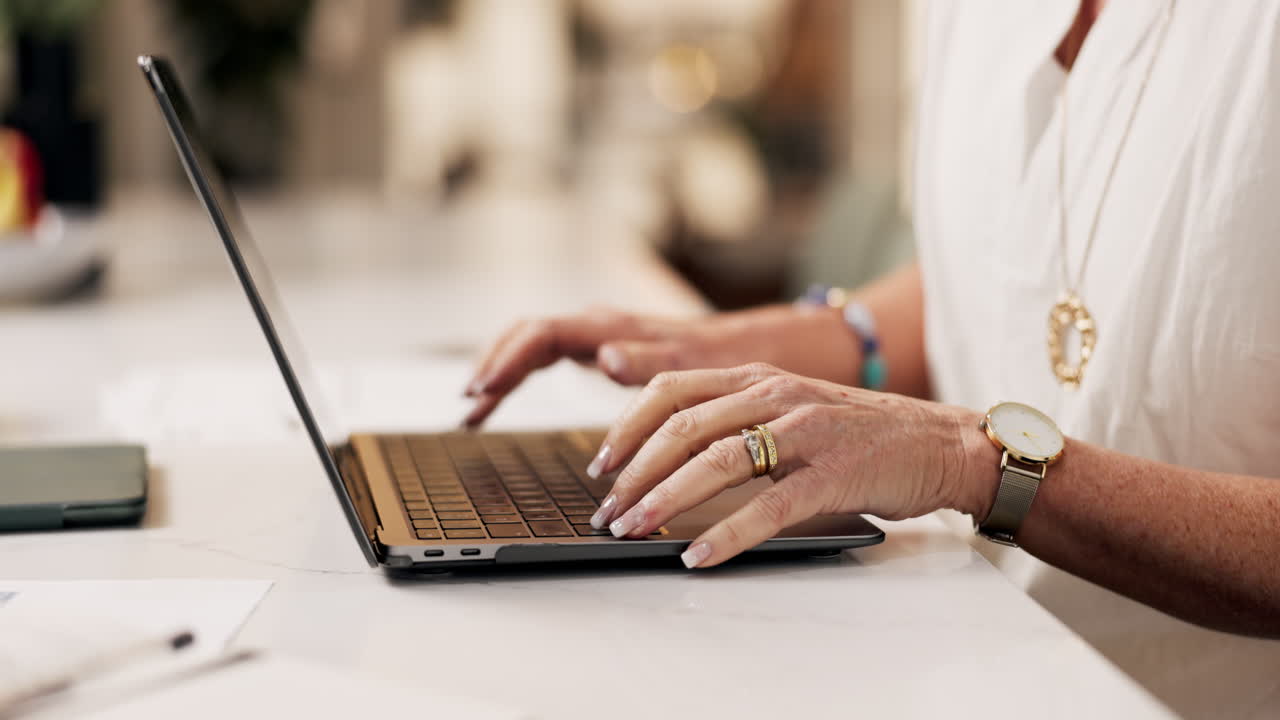 Woman typing on a laptop computer at a desk