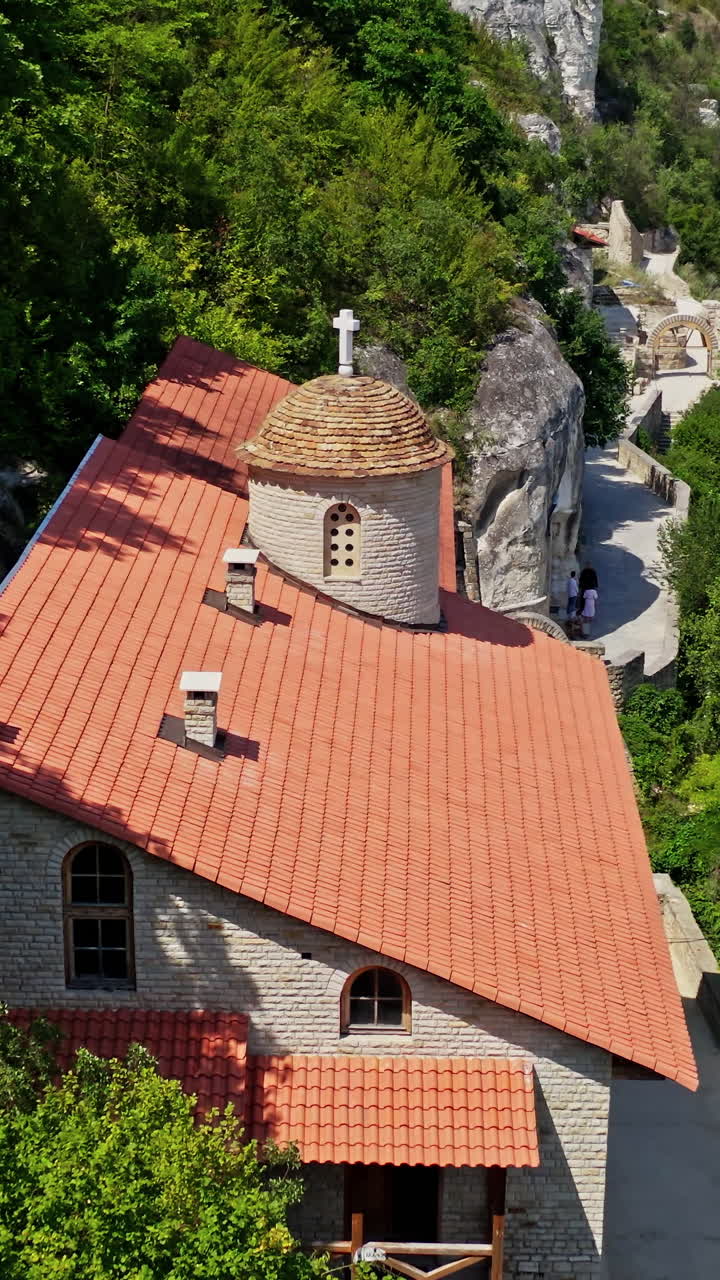 Monastery Building On Rock. Drone flight over mountain rock monastery. Vertical video
