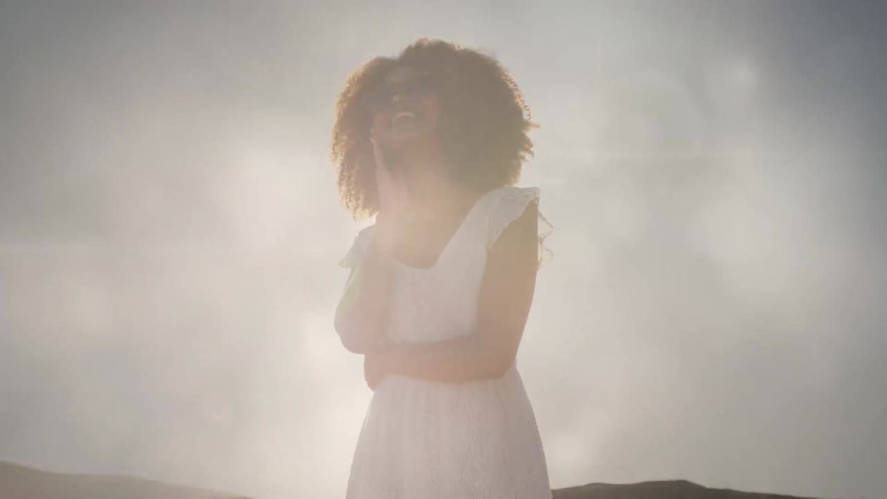 Animation of happy african american woman at beach over light spots