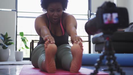 african american female plus size vlogger recording a video about working out