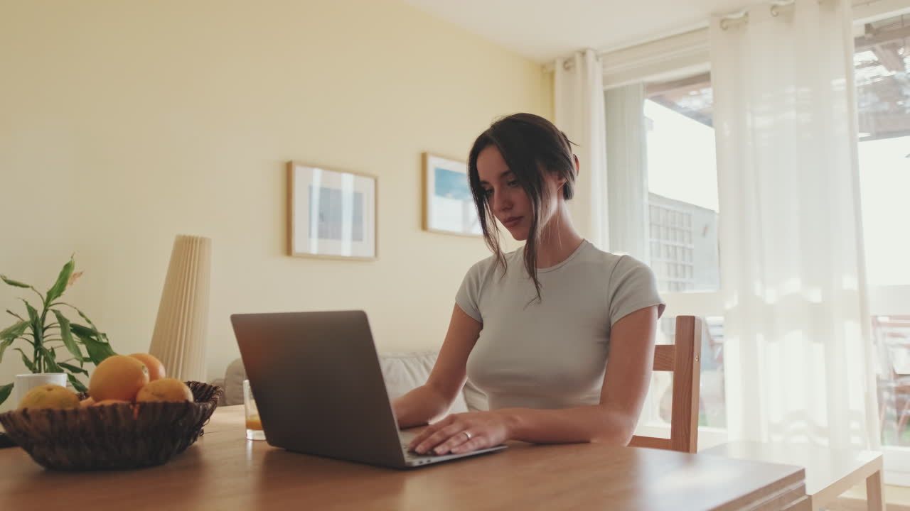 Woman working on a laptop at home