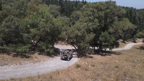 israel army squad soldiers on humvee vehicle driving through training ground country road, aerial shot