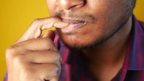 a man biting his fingernail