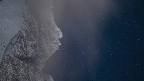 Timelapse-of-snow-covered-mountain-with-sky-filled-of-moving-stars