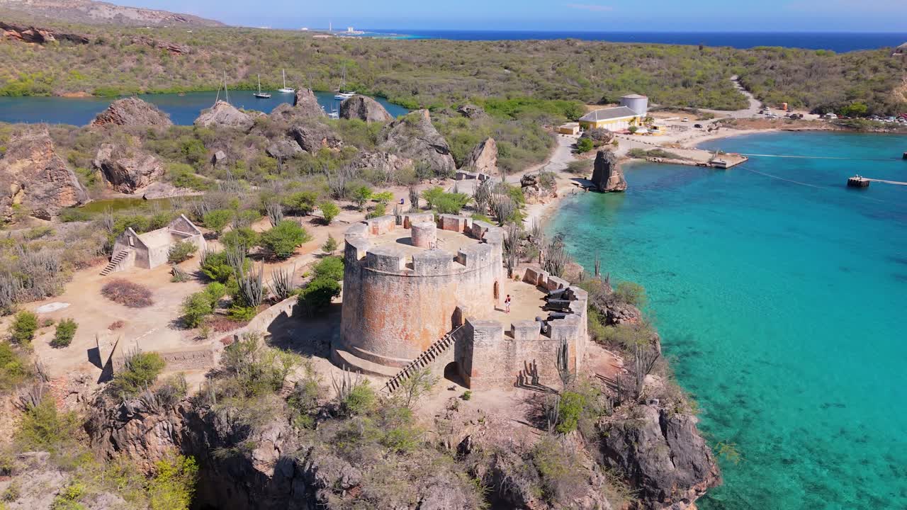 Aerial establishing pullback around old historic Fort Beekenburg overlooking coastal waters of Curacao