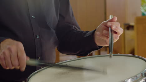 close up male musician playing snare drum in orchestra live concert