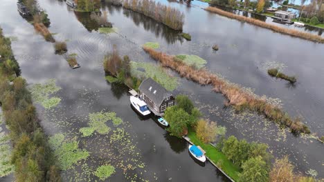small leisure house at miniature islands, loosdrecht, large water sports and nature reserve. aerial drone video.