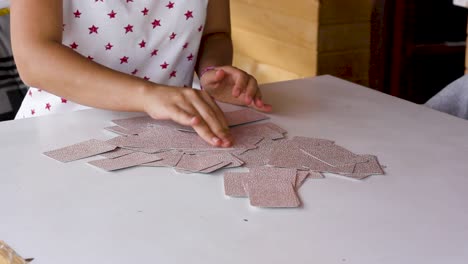 Woman-scrambling-tarot-cards-and-picking-random-one,-close-up