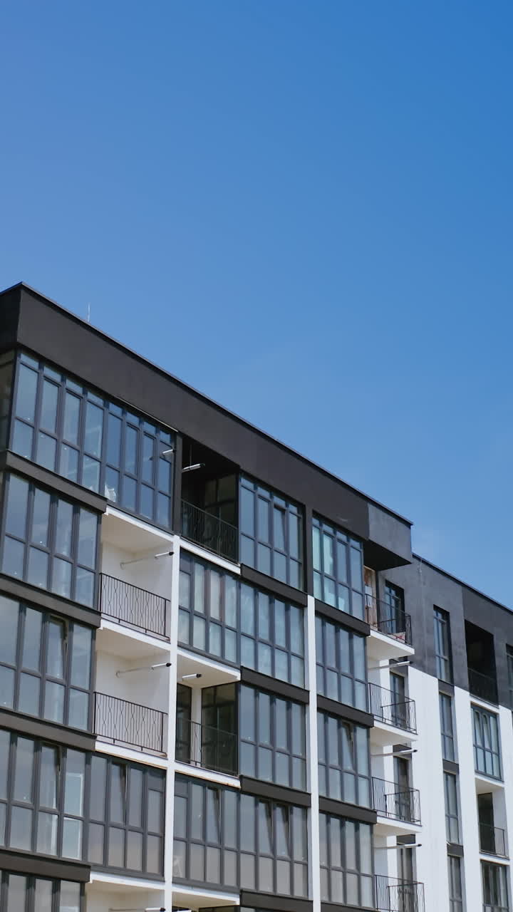 Modern urban residential area. Aerial drone view of building of apartment complex. Vertical video
