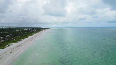 cuyo, mexico, showing a tropical beach, turquoise ocean, and cloudy sky , aerial view