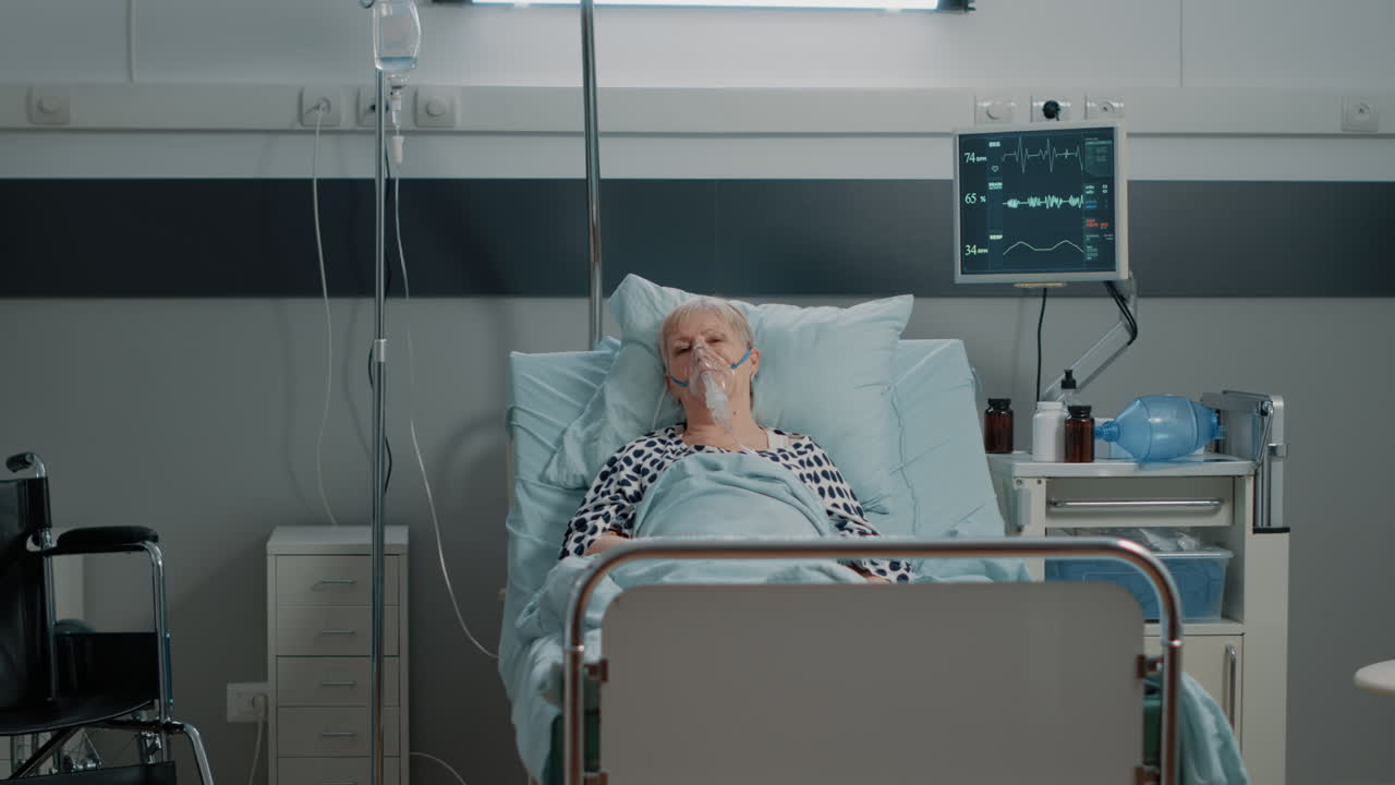 Doctor with hazmat suit doing checkup visit for aged woman