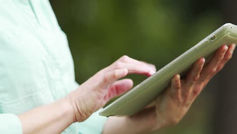 teacher using her tablet outside