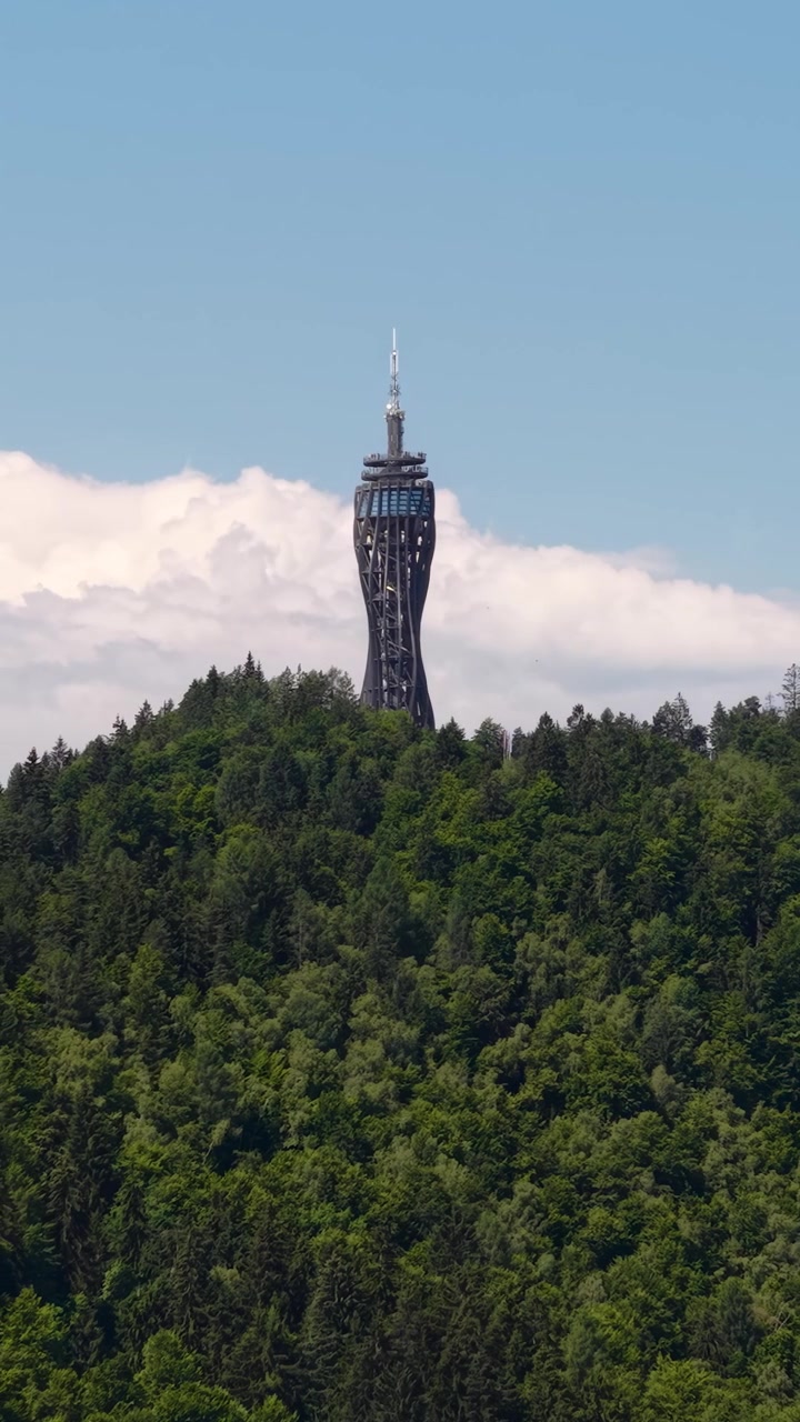 Vertical Drone Shot of Pyramidenkogel Tower, Observation Deck Above Maria Worth Village and Worthersee Lake, Austria