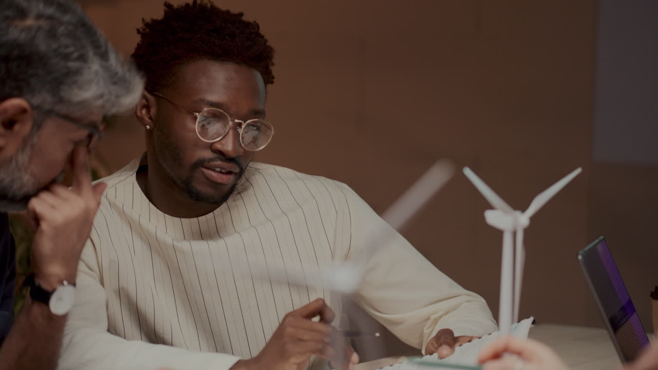 Diverse Colleagues Discussing Sustainable Energy Project at Meeting