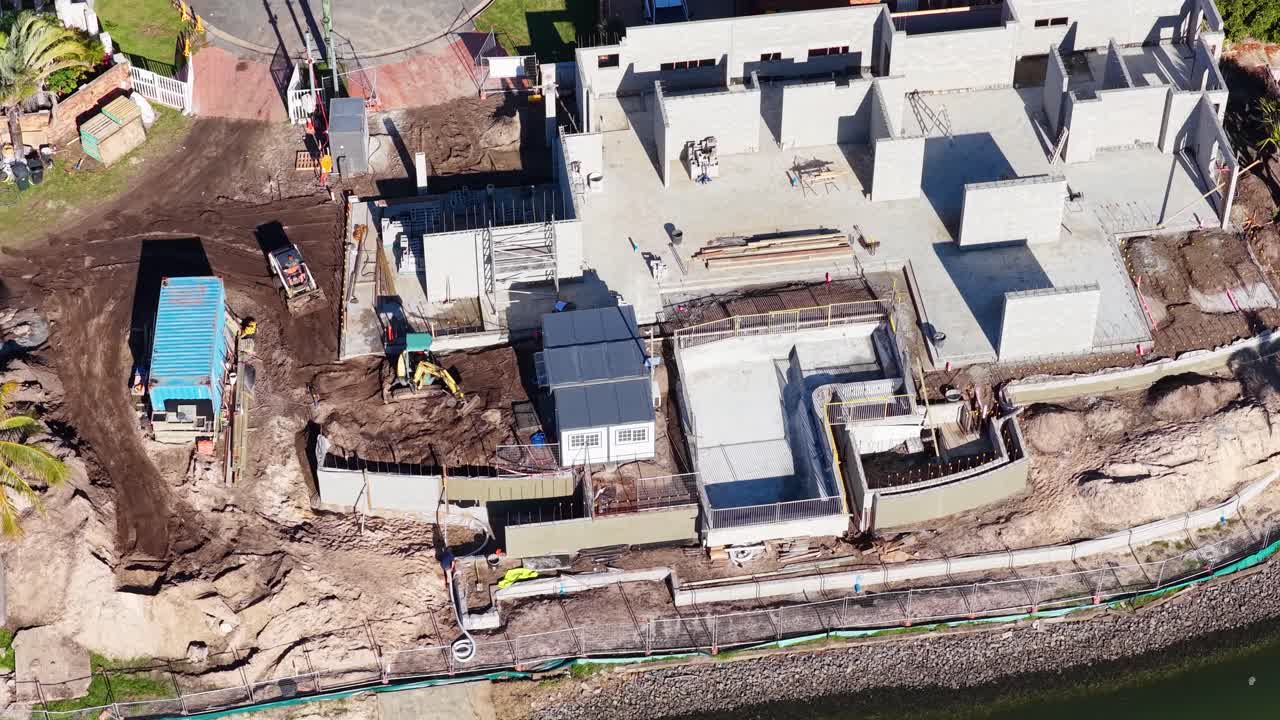 Aerial footage captures construction progress on a residential site in Gold Coast, Australia, highlighting machinery and workers in action