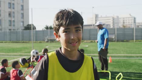 Niño-De-Fútbol-De-Raza-Mixta-Haciendo-Ejercicio-En-Un-Día-Soleado