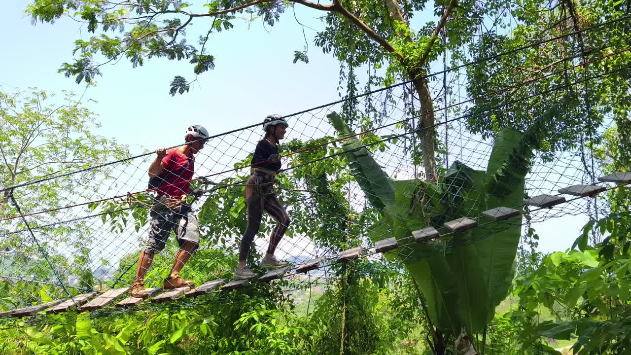 Couple enjoying a zip line adventure in the forest