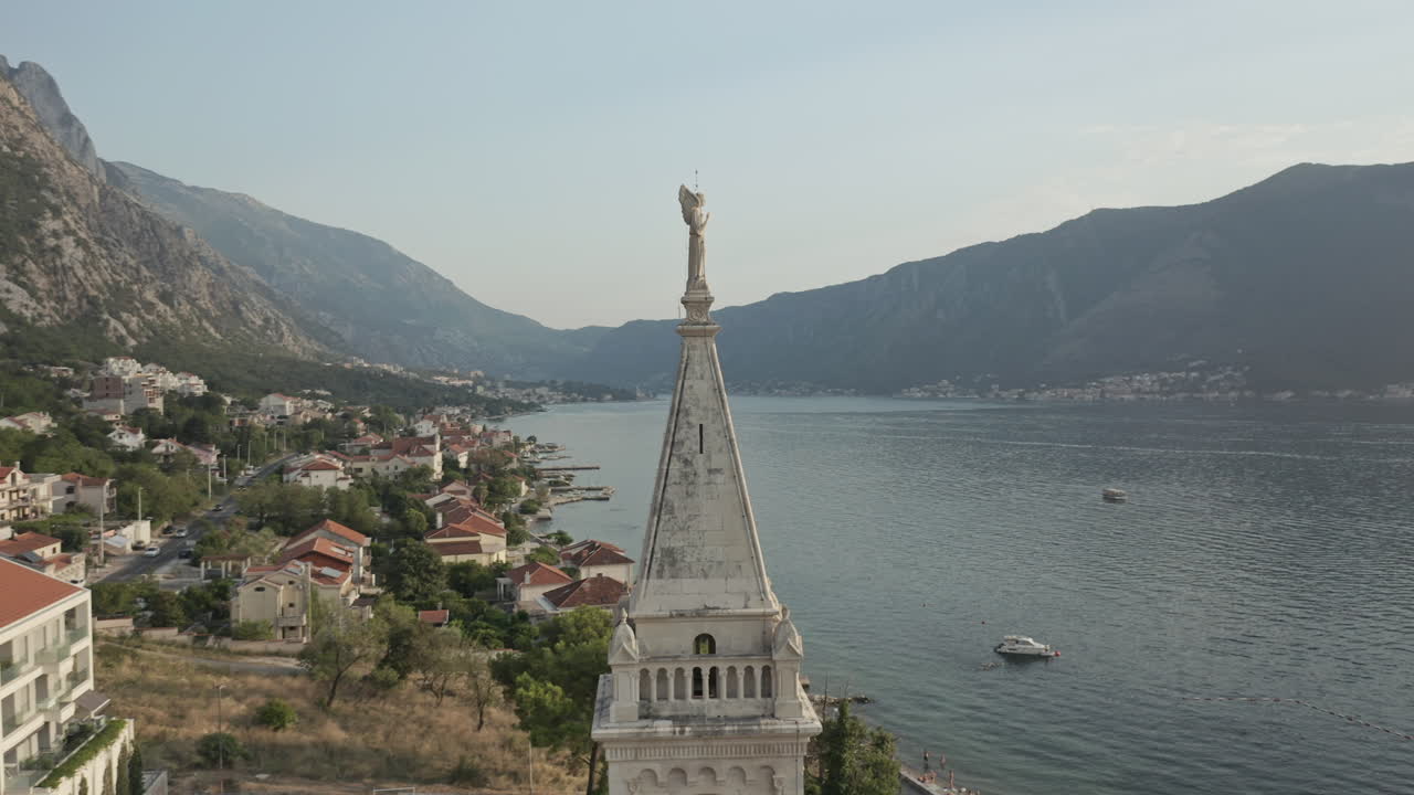 A small village overlooking the Bay of Kotor in Montenegro. Wide shot rotation around the Church of Saint Eustace