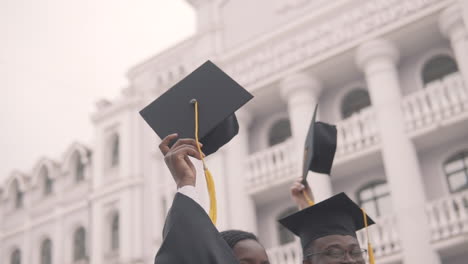 graduation cap flapped in the hands of a black female graduate