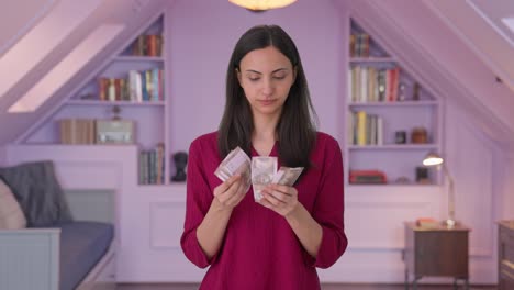 Serious-Indian-woman-counting-money