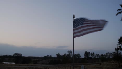 sunset in a farm display with old american flag, pan and hero shoot