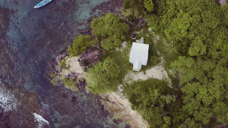 aerial birdseye view of treasure beach in jamaica with the beach and crystal clear waters and local boats moored in fishermans bay