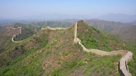 majestic view of the chinese great wall with watchtowers on lush mountains, serene mood