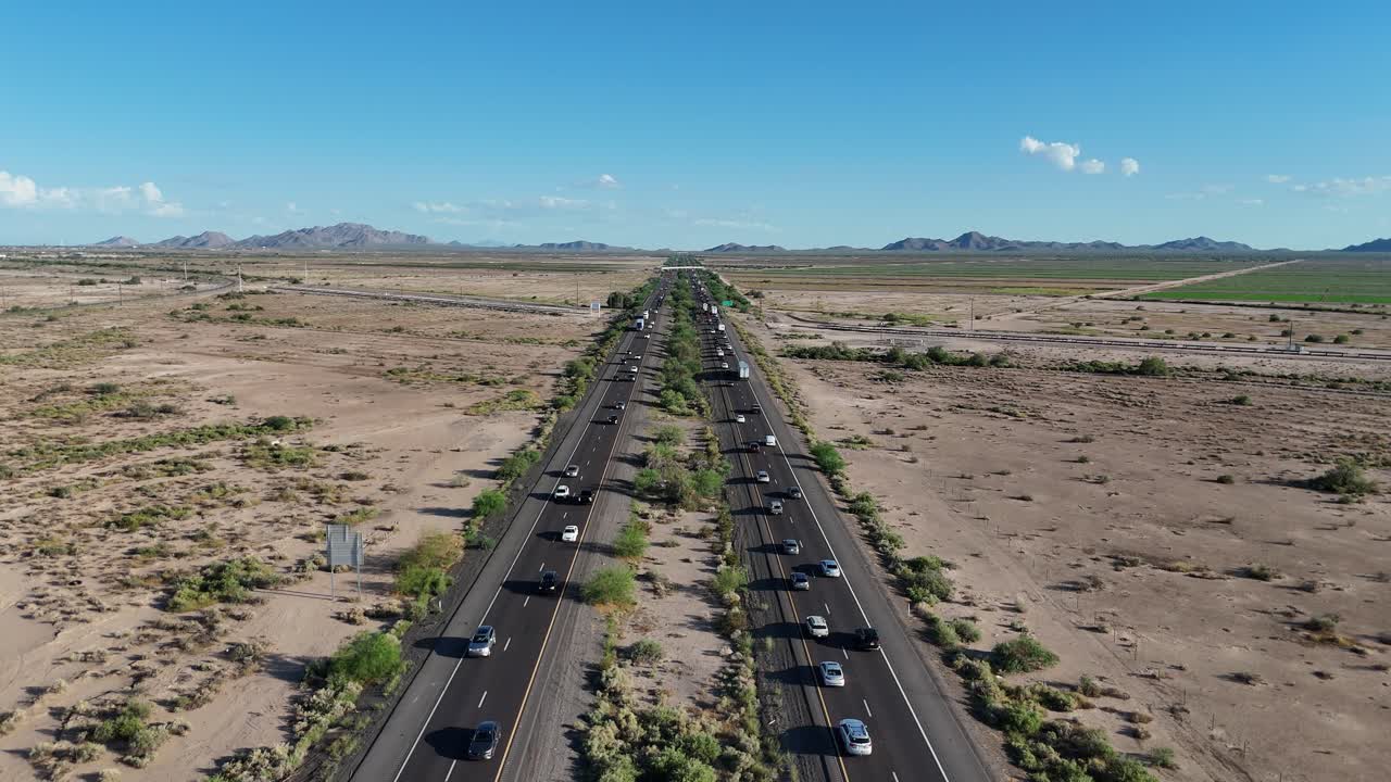 Aerial View of Cars Driving on Divided Highway in Desert, Interstate 10 in Southern Arizona, Blue Skies with few clouds, Mountains in background, static shot, late September