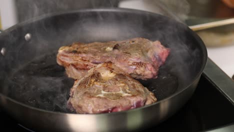 lamb chops frying in pan